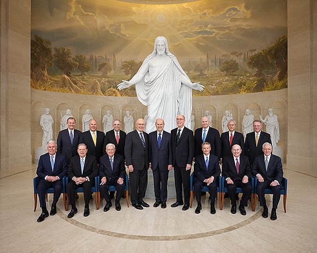 The First Presidency and the Quorum of the Twelve Apostles pose for a group portrait in the Rome Temple visitors’ centre, before the marble Christus and the statues of the original Twelve Apostles.